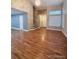 Open-concept living area with wood floors, large windows and neutral walls at 6973 Summerset Ave, Longmont, CO 80504