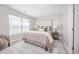This bedroom offers a cozy atmosphere with a plush rug and plenty of natural light from the window at 15608 E Otero Cir, Centennial, CO 80112