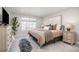 A tranquil bedroom showcasing natural light, neutral walls, layered textures, and a large window at 15608 E Otero Cir, Centennial, CO 80112