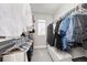 Well-organized walk-in closet with ample hanging space, shelving and a comfortable bench at 15608 E Otero Cir, Centennial, CO 80112