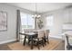 The dining room is filled with natural light, featuring a modern chandelier and access to a large outdoor deck at 15608 E Otero Cir, Centennial, CO 80112
