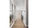 Long hallway with hardwood floors leading to dining area, enhanced by natural light at 15608 E Otero Cir, Centennial, CO 80112