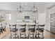 Kitchen boasts an island with stylish seating and modern pendant lighting, perfect for casual dining and entertaining guests at 15608 E Otero Cir, Centennial, CO 80112