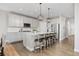 Spacious kitchen with a center island, stylish bar stools, stainless steel appliances, and bright, open floor plan at 15608 E Otero Cir, Centennial, CO 80112