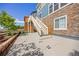 Wide patio with access to upper deck stairs, set in landscaped backyard with partial shade at 15608 E Otero Cir, Centennial, CO 80112