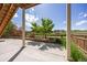 Open ground floor patio offering a serene view of the fenced backyard with lush greenery at 15608 E Otero Cir, Centennial, CO 80112
