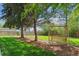 Picturesque backyard with a swing set, mature trees, and neatly manicured lawn at 6537 S Brentwood Way, Littleton, CO 80123