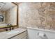 Charming bathroom featuring unique map wallpaper, granite counters, and elegant fixtures at 6537 S Brentwood Way, Littleton, CO 80123