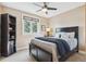 Cozy bedroom with ample natural light from the window, black shelving, and comfortable bedding at 6537 S Brentwood Way, Littleton, CO 80123