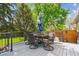 Inviting deck area with a round table, comfortable chairs, and an umbrella for shade at 6537 S Brentwood Way, Littleton, CO 80123