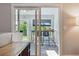 Indoor dining area with natural light, modern bar stools, and serene backyard view at 6537 S Brentwood Way, Littleton, CO 80123