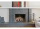 Close up view of living room fireplace with decorative objects and painted gray brick at 6537 S Brentwood Way, Littleton, CO 80123