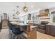 Open kitchen with bar seating, stainless steel appliances, and dark wood cabinetry providing a modern, inviting space at 6537 S Brentwood Way, Littleton, CO 80123