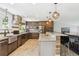 Modern kitchen with island seating, stainless steel appliances, and stone countertops, great for cooking and entertaining at 6537 S Brentwood Way, Littleton, CO 80123