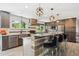 Modern kitchen with granite countertops, stainless steel appliances, and a spacious island with bar seating at 6537 S Brentwood Way, Littleton, CO 80123
