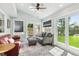 Bright sunroom with skylight, two seating areas and backyard view through French doors at 6537 S Brentwood Way, Littleton, CO 80123