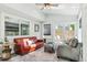 Inviting sunroom with multiple seating areas, natural light, and access to outdoor space at 6537 S Brentwood Way, Littleton, CO 80123
