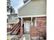 Charming condo entrance features brick accents, covered porch, and stairway to the upper level at 912 S Dearborn Way # 3, Aurora, CO 80012