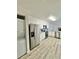 Modern kitchen with stainless steel appliances, gray backsplash and white cabinets with wood floors and stone counters at 912 S Dearborn Way # 3, Aurora, CO 80012