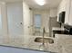 Well-equipped kitchen featuring white cabinets, stainless appliances, granite countertops, and modern finishes at 912 S Dearborn Way # 3, Aurora, CO 80012