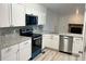 Modern kitchen featuring stainless appliances, white cabinets, gray subway tile backsplash, and granite countertops at 912 S Dearborn Way # 3, Aurora, CO 80012