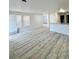 Spacious living area featuring durable gray wood floors and light-filled windows that add to the appeal of the home at 912 S Dearborn Way # 3, Aurora, CO 80012