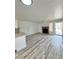 Bright, open-concept living room featuring a modern fireplace, wood floors and a kitchen with granite countertop at 912 S Dearborn Way # 3, Aurora, CO 80012