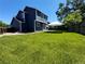 Expansive backyard with a well-manicured lawn and tent, perfect for outdoor activities at 16840 Hoot Owl Ct, Parker, CO 80134