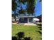 Backyard view featuring a well-maintained lawn, patio, and outdoor dining set at 16840 Hoot Owl Ct, Parker, CO 80134