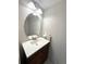 Bathroom featuring an oval mirror and a dark wood vanity with white countertop at 16840 Hoot Owl Ct, Parker, CO 80134