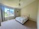 Bright bedroom with ceiling fan, carpet, and large window at 16840 Hoot Owl Ct, Parker, CO 80134