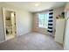Spacious bedroom with ensuite bathroom access, a large window, and carpeted flooring at 16840 Hoot Owl Ct, Parker, CO 80134