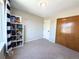 Comfortable bedroom with closet, a window, and a built-in bookcase for storage and display at 16840 Hoot Owl Ct, Parker, CO 80134