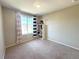 Well-lit bedroom with a large window and shelving, creating a comfortable space at 16840 Hoot Owl Ct, Parker, CO 80134
