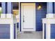 Close-up of the front door with stylish hardware and a charming light fixture, inviting guests inside at 16840 Hoot Owl Ct, Parker, CO 80134