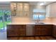 Well-lit kitchen with white countertops, wood cabinets and stainless steel dishwasher at 16840 Hoot Owl Ct, Parker, CO 80134