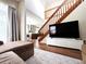 Bright living area with a staircase and a large TV, creating a welcoming atmosphere at 16840 Hoot Owl Ct, Parker, CO 80134