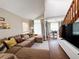 Bright living area with a staircase and a comfortable sectional sofa, creating a welcoming atmosphere at 16840 Hoot Owl Ct, Parker, CO 80134