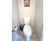 Toilet nook featuring a standard white toilet with tiled floor and wall art at 16840 Hoot Owl Ct, Parker, CO 80134