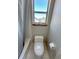 Cozy nook with a standard white toilet next to a shower and small window at 16840 Hoot Owl Ct, Parker, CO 80134