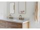 Close-up of bathroom vanity with marble countertop and gold fixtures, plus modern mirrors and towels at 3363 W 32Nd Ave, Denver, CO 80211