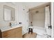 Stylish bathroom featuring modern vanity, mirror, and a shower-over-tub with brass fixtures at 3363 W 32Nd Ave, Denver, CO 80211