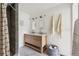 Modern bathroom featuring a double vanity, stylish mirrors, and a beautifully tiled shower at 3363 W 32Nd Ave, Denver, CO 80211