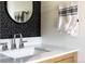 Close-up of bathroom vanity featuring a stone countertop, undermount sink, and modern fixtures at 3363 W 32Nd Ave, Denver, CO 80211