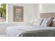 Close up of a bedroom with a bed, neutral decor, and a framed painting at 3363 W 32Nd Ave, Denver, CO 80211
