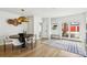 Modern dining room with dark table, white chairs, light hardwood floors and natural light at 3363 W 32Nd Ave, Denver, CO 80211