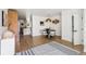 Bright dining room featuring wood floors, modern lighting, and an open layout connected to the kitchen area at 3363 W 32Nd Ave, Denver, CO 80211