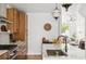 Kitchen features a large island with sink, wood cabinets, and view into living room at 3363 W 32Nd Ave, Denver, CO 80211