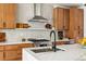 Close up on kitchen features including gas range, quartz countertops, and stainless exhaust hood at 3363 W 32Nd Ave, Denver, CO 80211
