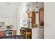 Kitchen features island, seating, modern pendant lights and stainless refrigerator at 3363 W 32Nd Ave, Denver, CO 80211